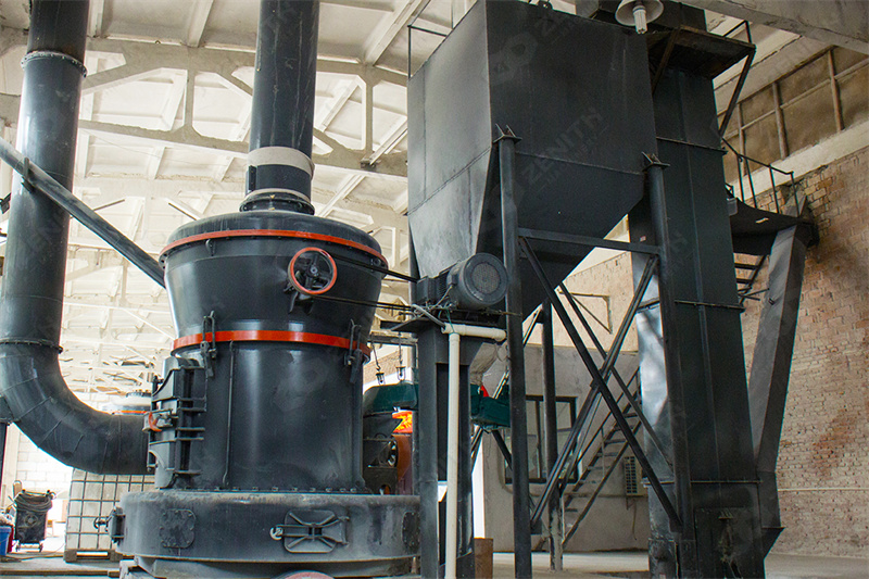 Technician replacing grinding roller in vertical mill